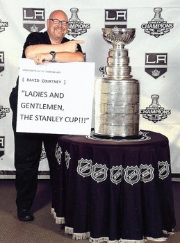 Longtime L.A. Kings announcer David Courtney poses with the Stanley Cup.