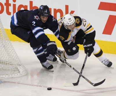 Adam Pardy of the Winnipeg Jets fights for the puck against Daniel Paille of the Boston Bruins during a preseason game at the MTS Centre in Winnipeg on September 26, 2013. (Marianne Helm/Getty Images North America)