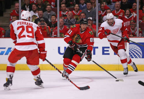 Landon Ferraro tries to prevent Marian Hossa from creating a scoring chance in a preseason game on September 23rd in Chicago. (Photo by Jonathan Daniel/Getty Images)