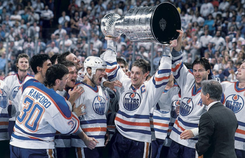 Wayne Gretzky is all smiles as Bill Ranford, Esa Tikkanen, Mark Messier, and Kevin Lowe look on after Edmonton defeated Boston in five games to claim the 1988 Stanley Cup. (David E. Klutho/SI)