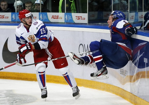 Russia's Zharkov checks Slovakia's Bires in their preliminary round game during the 2013 IIHF U20 World Junior Hockey Championship in Ufa