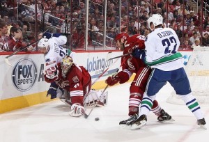  Goaltender Mike Smith #41 of the Phoenix Coyotes is hit from behind from Alexander Edler #23 of the Vancouver Canucks during the second period of the NHL game at Jobing.com Arena on March 21, 2013 in Glendale, Arizona. Edler received a 5 minute major penalty on the play.(Photo by Christian Petersen/Getty Images)