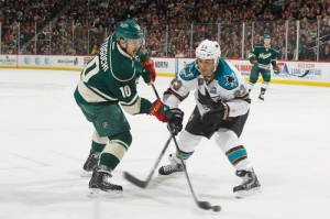  Devin Setoguchi #10 of the Minnesota Wild shoots the puck with Scott Gomez #23 of the San Jose Sharks defending during the game on March 23, 2013 at the Xcel Energy Center in Saint Paul, Minnesota. (Photo by Bruce Kluckhohn/NHLI via Getty Images)