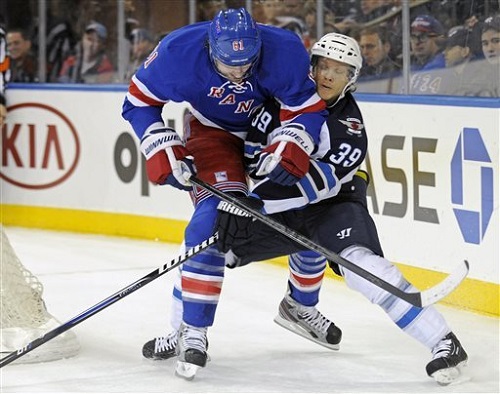 Winnipeg Jets' Tobias Enstrom, right, attempts to slow down New York Rangers' Rick Nash during the first period of an NHL hockey game Monday, April 1, 2013, at Madison Square Garden in New York. Source: AP Photo/Bill Kostroun