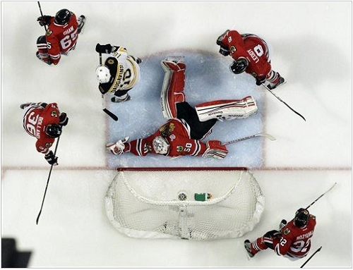 Chicago Blackhawks goalie Corey Crawford (50) makes a save during the first overtime period of Game 1 in their NHL Stanley Cup Final hockey series against the Boston Bruins, Thursday, June 13, 2013, in Chicago. (AP Photo/Nam Y. Huh)