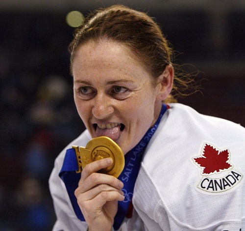 Canadian women's hockey team member Geraldine Heaney licking her gold medal after their win over the United States at the XIX Olympic Winter Games in Salt Lake City, Utah. (AP Photo/The Canadian Press, Tom Hanson, File)