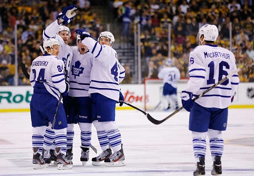 Cody Franson celebrates with teammates after scoring his second goal of the game