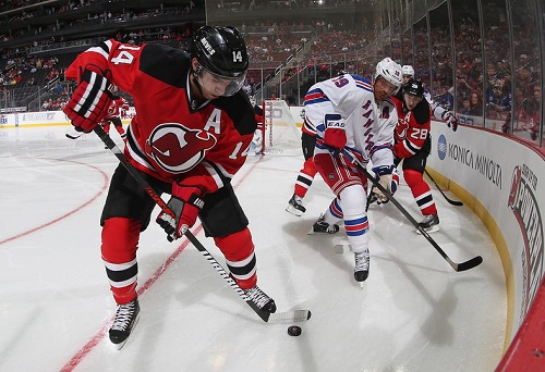 Adam Henrique #14 of the New Jersey Devils moves the puck against the New York Rangers during a preseason game at the Prudential Center on September 16, 2013 in Newark, New Jersey. Credit: Bruce Bennett/Getty Images