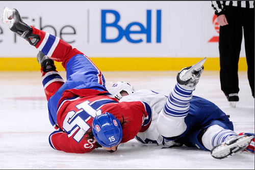 MONTREAL, QC - OCTOBER 1: George Parros #15 of the Montreal Canadiens falls to the ice head first during his their period fight with Colton Orr #28 of the Toronto Maple Leafs during the NHL game at the Bell Centre on October 1, 2013 in Montreal, Quebec, Canada. The Maple Leafs defeated the Canadiens 4-3. (Credit to Richard Wolowicz/Getty Images)