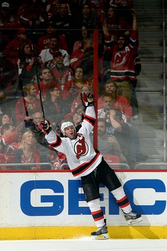 Andy Greene #6 of the New Jersey Devils celebrates after scoring the game winning goal in overtime during an NHL game against the Washington Capitals at Verizon Center on December 21, 2013 in Washington, DC. (Photo by Patrick McDermott/NHLI via Getty Images)