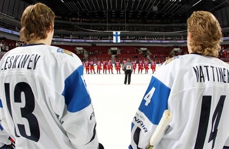 MALMO, SWEDEN - DECEMBER 30: Finland's Ville Leskinen #13 and Topi Nattinen #14 look on during the national anthem after a 4-1 preliminary round win over Russia at the 2014 IIHF World Junior Championship.  (Photo by Andre Ringuette/HHOF-IIHF Images)