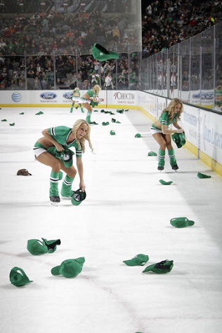 Stars Ice Girls retrieve hats from the ice