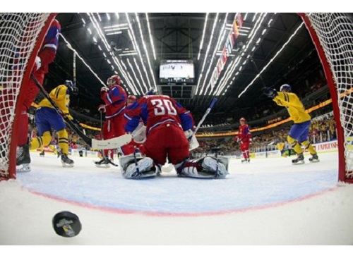 Russia's Andrei Vasilevski #30 looks as Sweden players celebrate after taking a 1-0 lead in preliminary round action at the 2014 IIHF World Junior Championship. credit: Photo by Andre Ringuette/HHOF-IIHF Images