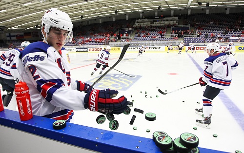 #2 Brady Skjei scoops the pucks off the boards for warm-up prior to  preliminary round game against Canada at the 2014 IIHF World Junior Championship. (Photo by Francois Laplante/HHOF-IIHF Images)