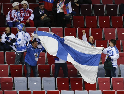 Finnish fans celebrate after the 3-1 win over Russia. Photo Credit: (AP Photo/Julio Cortez)