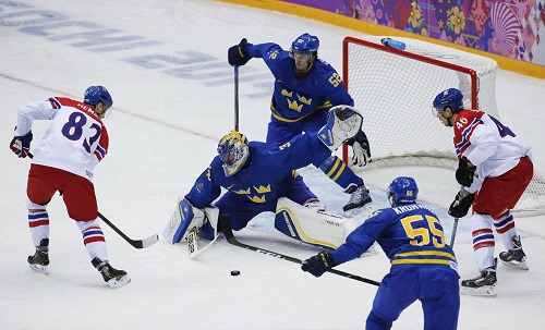 Henrik Lundqvist makes one of his 27 saves en route to a Swedish victory