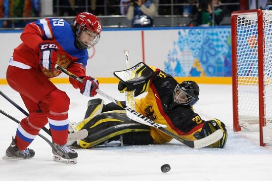 Goalkeeper Viona Harrer of Germany blocks Anna Shokhina of Russia shot at the goal during the first period of the 2014 Winter Olympics women's ice hockey game at Shayba Arena, Sunday, Feb. 9, 2014, in Sochi, Russia.  (Photo by Petr David Josek, AP) 