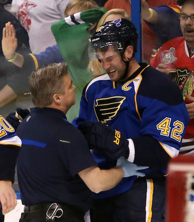 Head medical trainer for the Blues, Ray Barile, helps keep captain David Backes stable after taking a hit to the head by Brent Seabrook. Seabrook was later suspended three games for the hit. (Photo by Chris Lee/AP Photo/St. Louis Post-Dispatch)