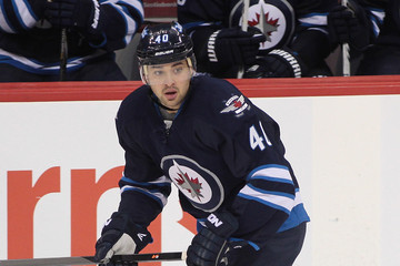 Jets forward Devin Setoguchi skating along the boards during a game against the Vancouver Canucks on March 12, 2014. (Getty Images)