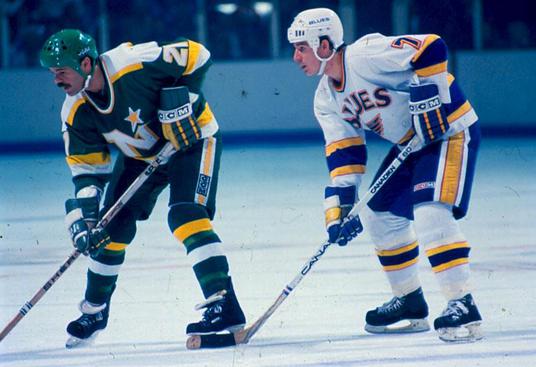 Joe Mullen lines up along side a foe from the Minnesota North Stars. Mullen wasn't always top of the scoring charts, but he made the most of his opportunity with the Blues. (Photo from NHL.com)