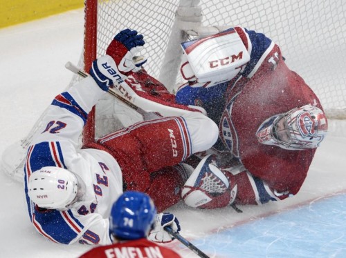 Chris Kreider crashes in to Canadiens Goalie Carey Price. Price is done for the Eastern Conference Finals with a knee injury as a result of this collision. (Photo by Adrian Wyld – AP)