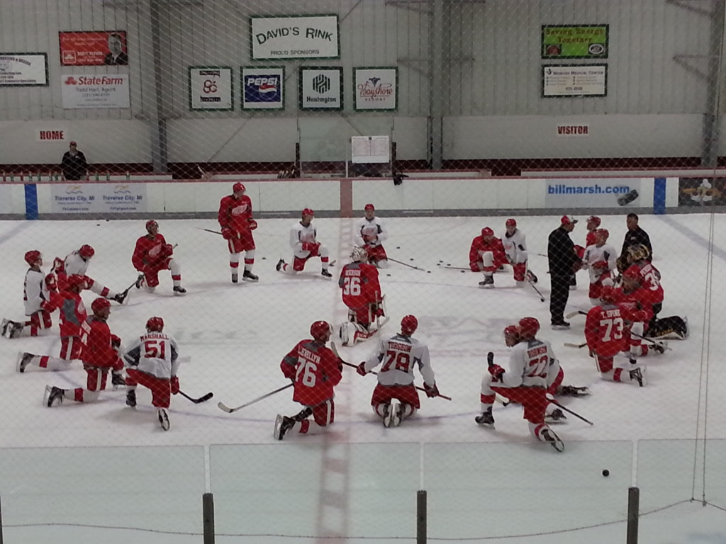 Members of Team Lidstrom stretch after their on-ice training session Saturday morning.