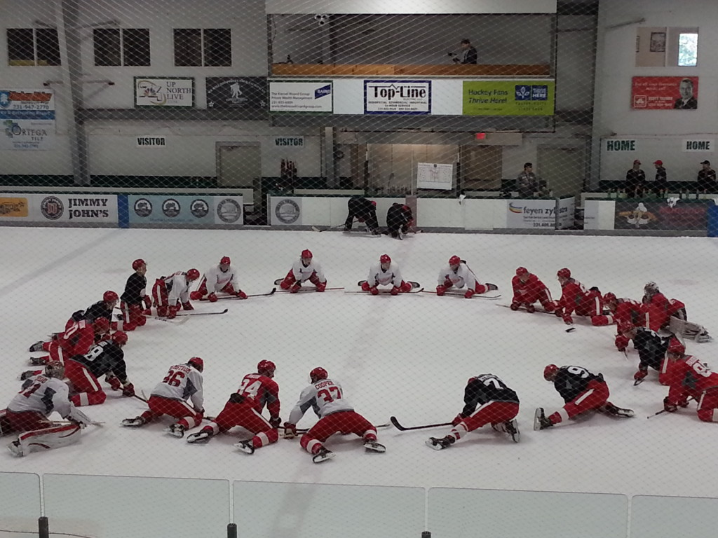 Members of Team Yzerman stretch before heading to the locker room following their first on-ice drills of the camp. (Photo taken by author)