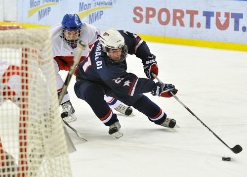 MINSK, BELARUS- APRIL 20: USA's Rocco Grimaldi #21 looks for a scoring chance while Bohumil Jank #3 of the Czech Republic defends during quarterfinal game action at the 2010 World Men's U18 Championship.  (Photo by Matthew Manor/HHOF-IIHF Images)