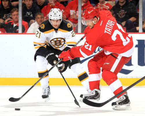 A pair of 21s battle for the puck. Tomas Tatar would score one of Detroit's two goals in the contest. (Dave Reginek/NHLI via Getty Images)