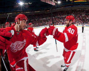 Stephen Weiss congratulates Henrik Zetterberg after the captain added an empty-net goal. (Photo by Dave Reginek/NHLI via Getty Images)