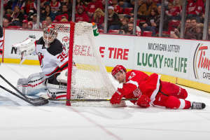 Detroit's Darren Helm scores a wraparound goal past Devils netminder Cory Schneider on New Year's Eve 2014. (Photo by Dave Reginek/NHLI via Getty Images)