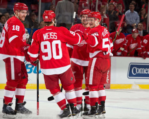 Teemu Pulkkinen celebrates with his teammates after scoring his first NHL goal January 20, 2015. (Photo by Dave Reginek/NHLI via Getty Images)