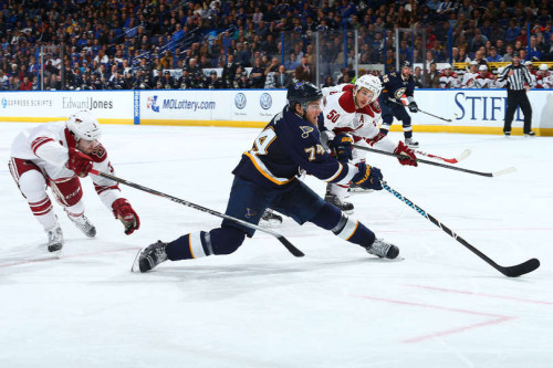 #74 T.J. Oshie throws in a few aerobatic moves to keep the Blues ahead of the Coyotes during Tuesday night's game. (Dilip Vishwanat/Getty Images) 