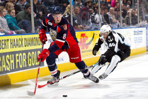 Anthony Mantha (on left) battles for the puck with Milwaukee's Pontus Åberg during a game on February 27th, 2015. (Photo by: Jeff Hanisch / Milwaukee Admirals)