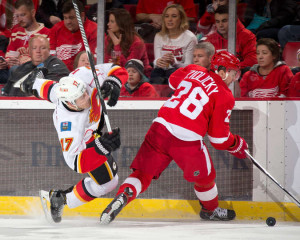Detroit's Marek Zidlicky skates past a falling Lance Bouma in a game against the Calgary Flames on March 6, 2015. (Photo by Dave Reginek/NHLI via Getty Images)