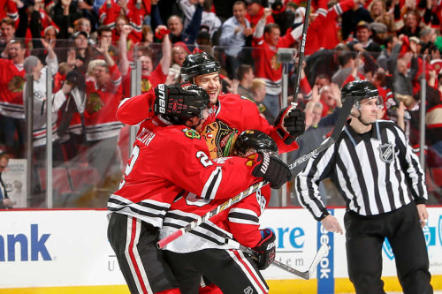 A very happy Brent Seabrook celebrates his 3OT game-winning goal in Game Four with teammates Duncan Keith and Patrick Kane. (Bill Smith – NHLi via Getty Images)