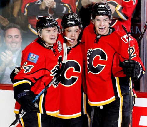 From left to right, Calgary Flames forwards Jiri Hudler, Johnny Gaudreau and Sean Monahan celebrate after a goal. The trio make up the Flames' best line. (Al Charest/Calgary Sun)