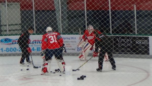 Goalies Joren Van Pottelberghe and Jake Paterson work with Red Wings goalie coach Jim Bedard before practice. (Photo by Author)