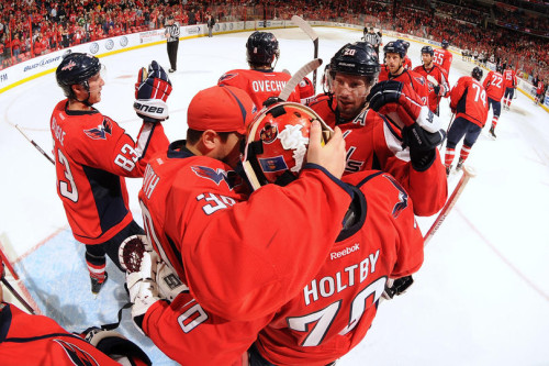 Capitals' goaltender Braden Holtby celebrates after the game with teammates  (Photo by Mitchell Layton/NHLI via Getty Images)