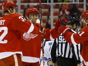 Forwards Louis-Marc Aubry and Daniel Cleary congratulate Drew Miller after his first period goal. Friday, September 2, 2015. (Rick Osentoski USA TODAY Sports)