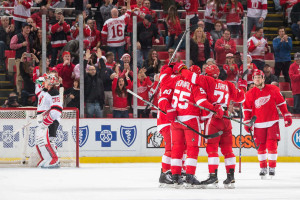 Dylan Larkin celebrates his first career power play goal with teammates Niklas Kronwall, Justin Abdelkader, and Henrik Zetterberg. (Photo by Dave Reginek/NHLI via Getty Images)