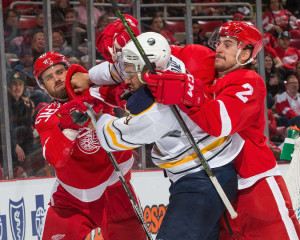 A battle ensues between Red Wings captain Henrik Zetterberg, defenseman Brendan Smith and Sabres forward Evander Kane in a game at Joe Louis Arena on December 1, 2015 in Detroit, Michigan. (Photo by Dave Reginek/NHLI via Getty Images)