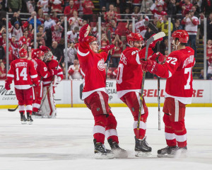 Rookie Andreas Athanasiou celebrates his first career shootout goal with teammates Dylan Larkin and Henrik Zetterberg at Joe Louis Arena on February 23, 2016. (Photo by Dave Reginek/NHLI via Getty Images)